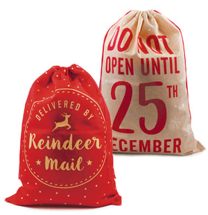 a red bag that says delivered by reindeer mail next to a brown bag that says do not open until 25th december