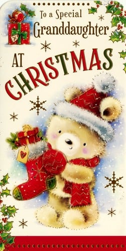 a teddy bear wearing a santa hat and scarf is holding a christmas stocking .