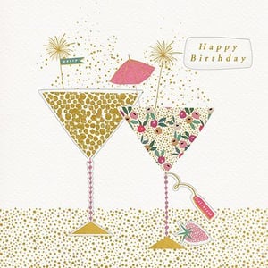 a happy birthday card with two martini glasses and fireworks .
