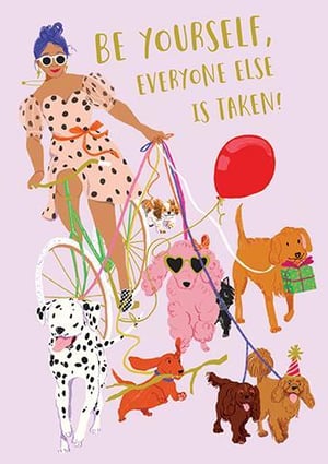 a woman is riding a bike with dogs and a balloon .