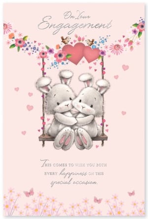 Two rabbits are sitting on a swing with hearts and flowers.
