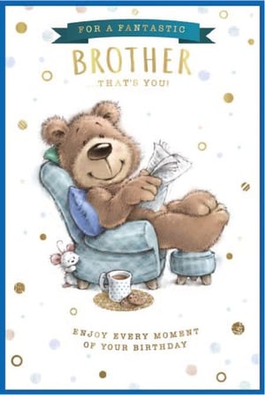 a teddy bear is sitting in a chair reading a newspaper .