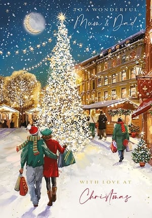 a christmas card with a couple walking in front of a christmas tree .