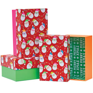 a stack of christmas boxes with one that says merry xmas on it