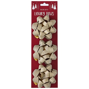 a pack of three gold luxury bows on a red card
