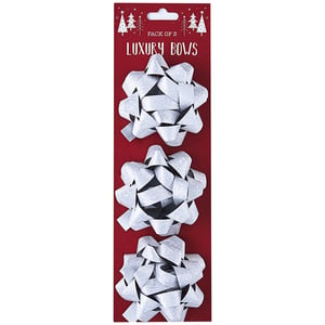 a pack of three silver luxury bows on a red background