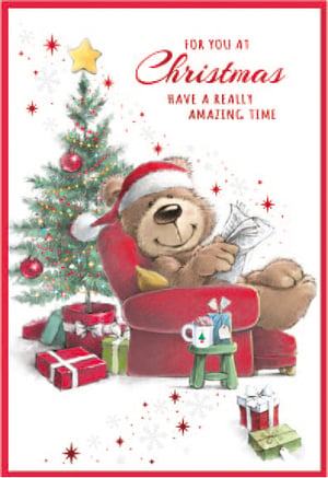 a christmas card with a teddy bear reading a newspaper