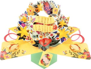 a pop up easter card with a wreath of flowers on it .