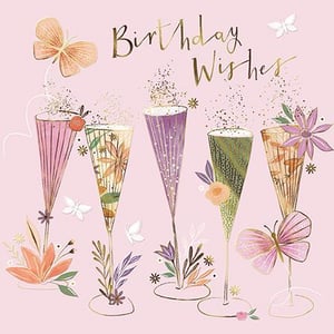 a birthday card with champagne glasses and flowers on a pink background .