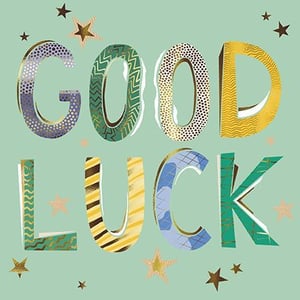 the word good luck is written in colorful letters on a green background .