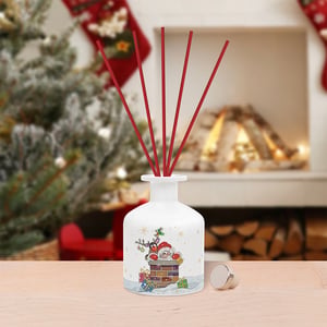 a white bottle with red sticks has a picture of santa on it