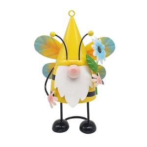 a gnome with a yellow hat and wings is holding a flower
