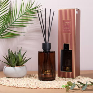 a desire home reed diffuser sits next to its box