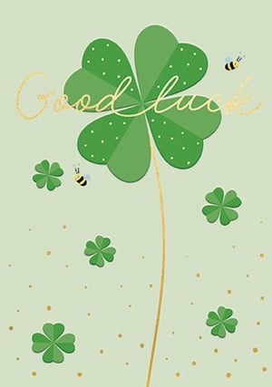 a four leaf clover with bees flying around it on a green background .