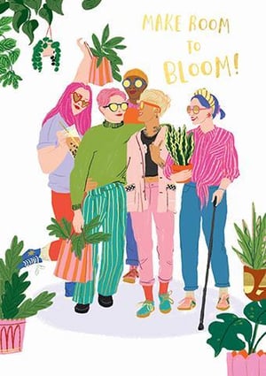a group of women are standing next to each other in front of potted plants .