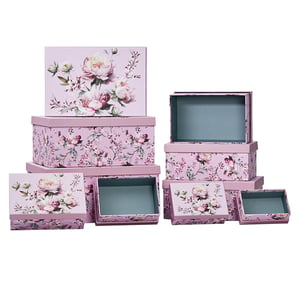 a stack of pink boxes with flowers on them