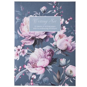 a writing set with pink flowers on a blue background