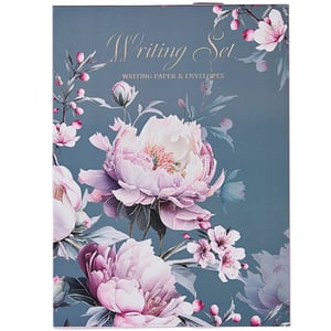 a writing set with pink flowers on a blue background