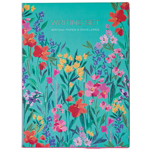 a writing set with colorful flowers on a blue background