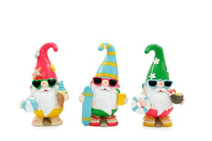 three colorful gnomes are standing next to each other on a white background