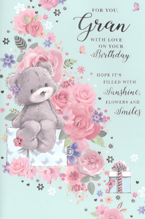 Celebrate your wonderful Gran's special day with this absolutely charming birthday card from Simon Elvin. Featuring an adorable grey teddy bear perched on a beautifully wrapped gift, surrounded by a delightful cascade of soft pink and purple flowers, this card is sure to bring a smile to her face.
The gentle blue background perfectly complements the sweet floral design and the heartfelt message: "FOR YOU, Gran WITH LOVE ON YOUR Birthday HOPE IT'S FILLED WITH Sunshine, FLOWERS AND Smiles". It's the perfect way to show your love and appreciation.
This lovely 'Gran' card is supplied in a convenient pack of 6, making it an ideal addition to your greeting card selection. Stock up on this popular design today!