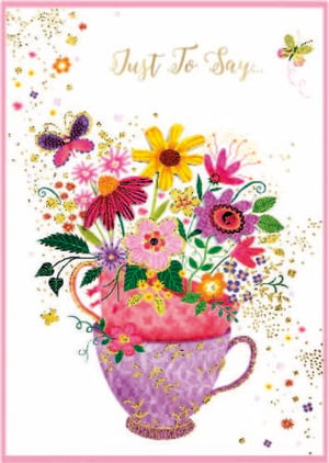 a greeting card with a teacup filled with flowers and butterflies .