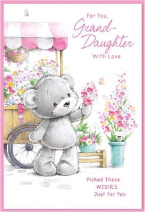 a teddy bear is holding a flower in front of a cart of flowers .