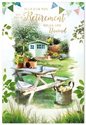 a retirement card with a picnic table and a shed in the background .