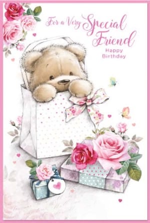 a teddy bear is sitting in a gift bag with roses and gifts .