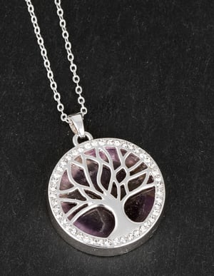 a necklace with a tree shaped pendant on a chain