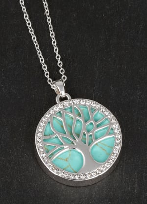a tree of life necklace with a turquoise stone in the center