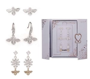 a set of silver bee earrings in a box