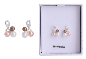 a pair of pearl earrings in a box on a white background .