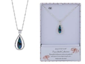 a necklace with a teardrop shaped pendant in a box .