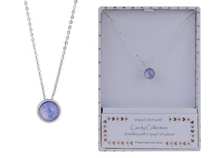 a necklace with a purple stone in a box .