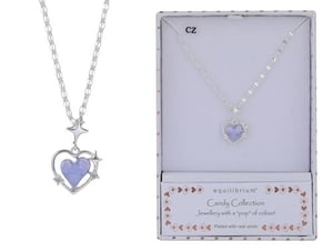 a necklace with a heart shaped pendant in a box .