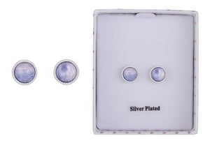 a pair of earrings in a box on a white background .