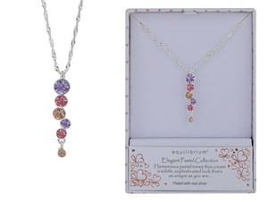 a necklace with pink , purple , and orange stones is in a box .