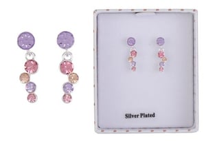 a pair of earrings in a box on a white background .
