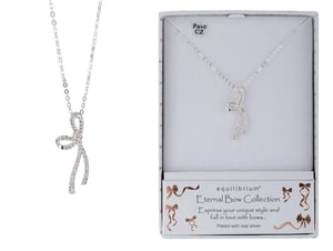 a necklace in a box that says equilibrium eternal bow collection