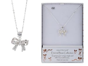 a necklace in a box that says equilibrium eternal bow collection