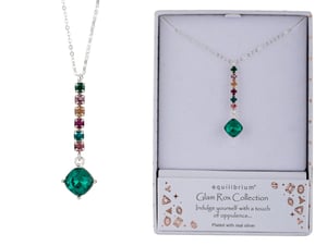 a necklace in a box that says equilibrium on it