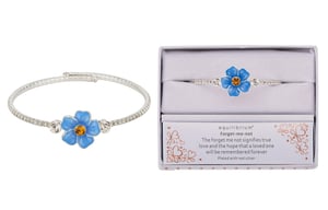 a bracelet with a blue flower and a card that says equilibrium