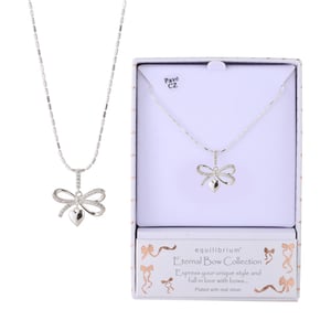 a necklace in a box that says equilibrium eternal bow collection