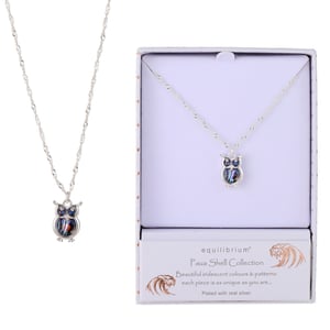 a necklace in a box that says equilibrium
