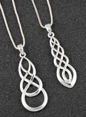 two silver necklaces with celtic knots on them on a black surface .