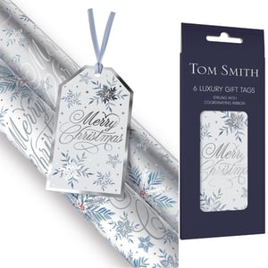 Introduce a touch of winter elegance to your Christmas collection with our 6 Gentle Snowfall Tags. These exquisite gift tags feature a delicate 'Merry Christmas' script in shimmering silver, beautifully complemented by intricate blue and grey snowflakes. Subtle hints of festive red berries add a charming warmth to the serene design.
Each luxurious tag boasts a sophisticated silver border and comes pre-strung with a coordinating light blue ribbon, ensuring a perfect finish for any gift. Presented in premium Tom Smith packaging, these tags are designed to catch the eye and enhance your customers' festive preparations. They pair wonderfully with matching wrapping paper for a truly coordinated look. Available in convenient packs of 25 from Design Group, these tags are an essential addition for retailers seeking quality Christmas accessories.