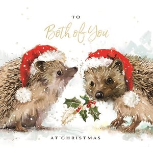 Offer your customers a charming choice this Christmas with Ling's 'To Both Of You' card. This sweet design features two hedgehogs, each wearing a festive Santa hat, in a gentle snowy scene. One hedgehog holds a sprig of holly, adding a traditional touch. The "To Both Of You" message makes it a popular option for sending warm wishes to couples or pairs. This appealing card captures the spirit of the season. Available in a convenient pack size of 1x6, it's a great addition to your seasonal greeting card range.