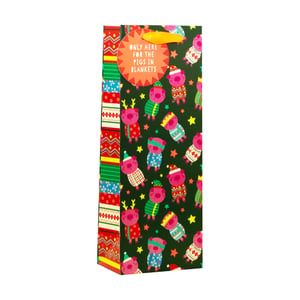 Get ready for festive gifting with our adorable Pigs In Blankets Bottle Bag! This charming bag features a delightful pattern of pink pigs dressed in a variety of colourful winter jumpers, hats, and scarves, set against a deep green background dotted with cheerful yellow stars.
A playful circular tag proudly declares, "ONLY HERE FOR THE PIGS IN BLANKETS," adding a touch of humour to any present. The vibrant striped side panel completes the festive look. Perfect for presenting wine, spirits, or other bottled treats, this bottle bag is sure to bring a smile to recipients this holiday season. It's a fun and unique way to wrap up a special gift, making it an ideal choice for Christmas and winter celebrations.