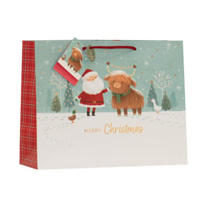 Bring festive cheer to your customers' gifting with our charming Medium Santa and Dougal Gift Bag. This delightful bag features a heartwarming scene of Santa Claus alongside a friendly Highland cow, 'Dougal', in a snowy winter wonderland. Complete with festive trees, playful ducks, and sparkling snowflakes, it's sure to bring a smile.
The vibrant design is complemented by a classic red tartan side panel and a matching gift tag, adding an extra touch of quality. The 'Merry Christmas' greeting in elegant gold script makes it perfect for any holiday present. Supplied by Partisan Products Ltd. in a convenient pack of 6, these medium-sized bags are ideal for a variety of gifts. A must-have for the festive season, offering both charm and practicality.